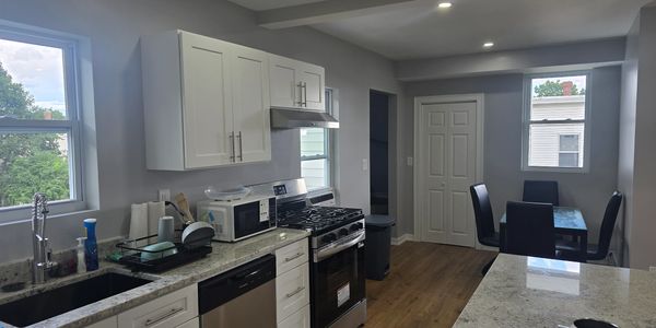 Modern kitchen with stove and dining area.