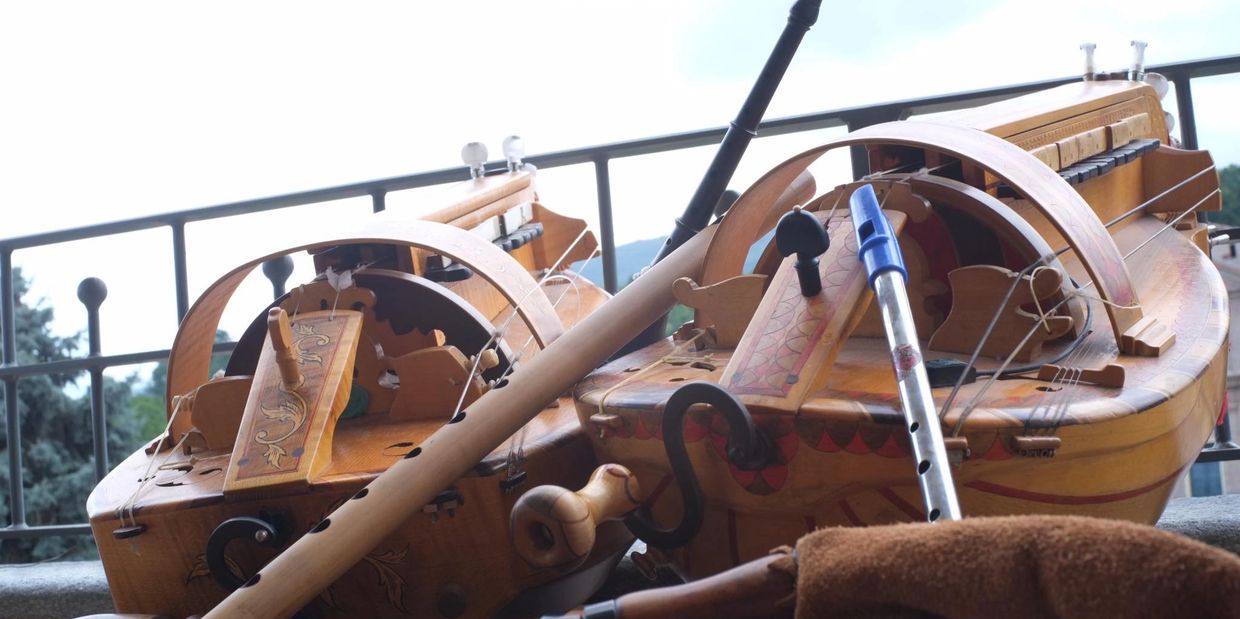 Traditional wooden musical instruments including hurdy-gurdies and flutes.