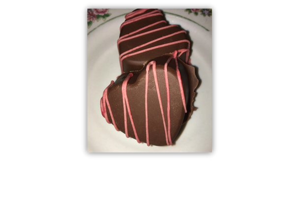 Heart chocolate bon-bons, with a pink chocolate drizzle