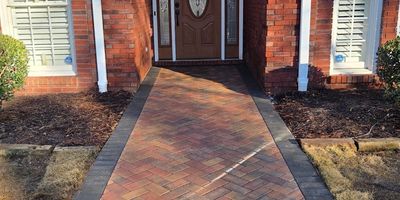 Walkway featuring custom hard scapes leading to a door entrance.