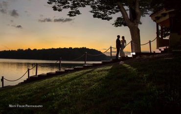 A backlit couple on the dock stairs