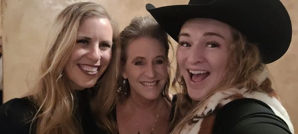 Three women taking a selfie on the camera with laughing