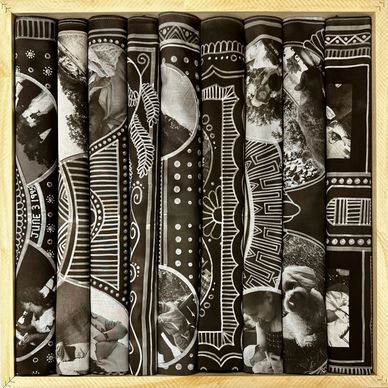 Rolled black and white photo scrolls with patterns.