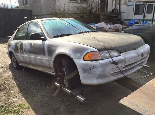 Junk car being removed from a residential property in Burnaby, BC