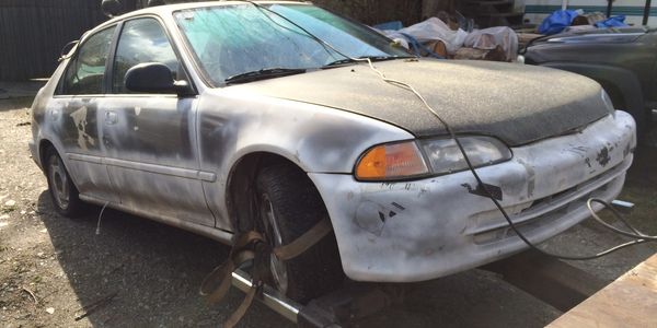 Junk car being removed from a residential property in Burnaby, BC
