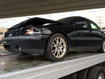 Scrap car towing in action – removing an old car from a parking lot