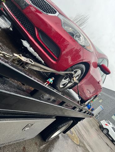 Wrecker towing a non-operational car in Burnaby for recycling