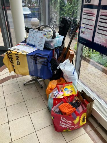 Donation collection for Ukraine with various items displayed.