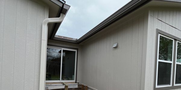 6 inch K style gutters with a matching downspout color.