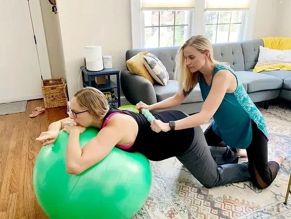 Doula demonstrating back pain relief 