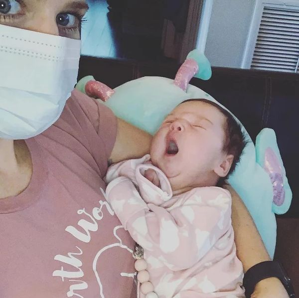 Doula holding new baby