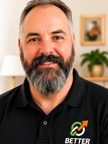 Smiling man with a beard wearing a black polo shirt with a 'Better' logo.