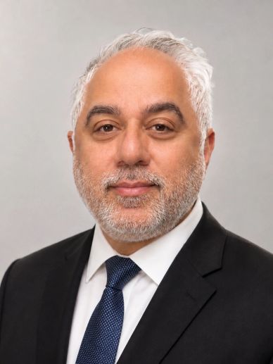 Professional headshot of a man in a suit.