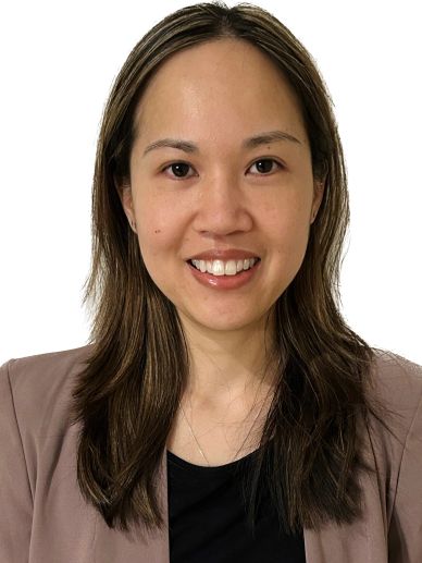 Smiling woman wearing a brown blazer and black top.