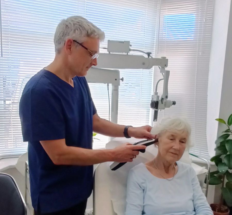 Michael Guy checking a patient's eardrum and middle ear with tympanometry