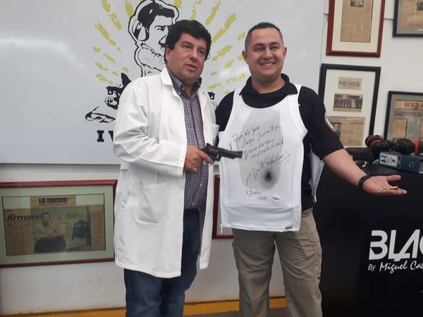 Doctor and man with bulletproof vest smiling in a studio.