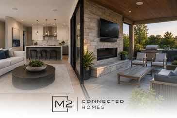 Modern indoor-outdoor living space with cozy seating and a fireplace.