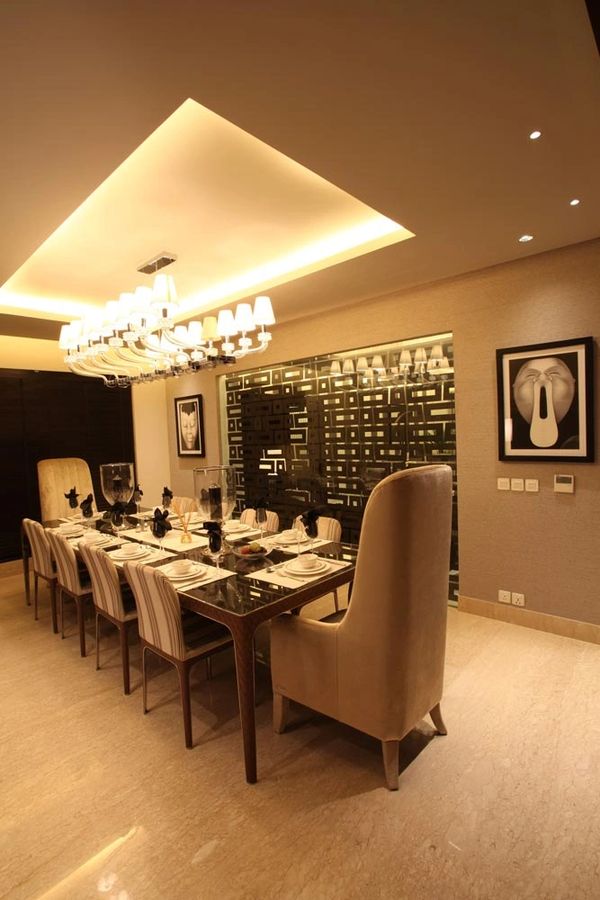 Elegant modern dining room with chandelier and art.