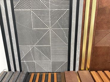 Decorative panels with geometric patterns and varied textures in black, gray, brown, and gold.