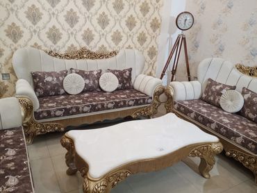 Elegant living room with ornate sofas and a decorative coffee table.