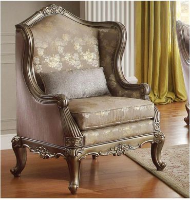 Elegant vintage armchair with floral upholstery and ornate wooden frame.