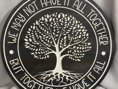 Decorative wooden plaque with an inspiring family unity quote and tree design.