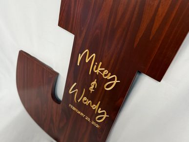Wooden cross with names Mikey and Wendy and date February 23, 2024.