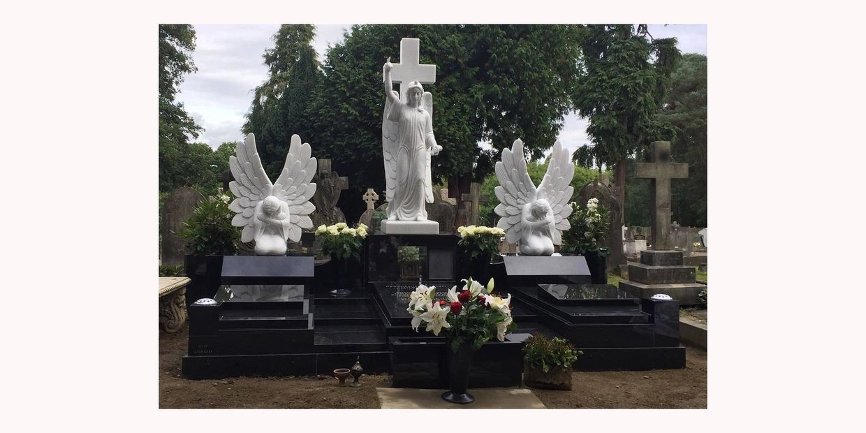 large black granite memorial with white marble angles