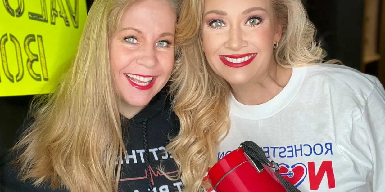 two nursing podcasters at a nursing strike holding a megaphone