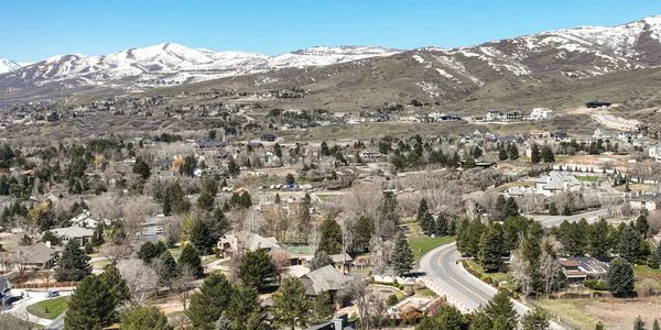 Suburban neighborhood with snow-capped mountains in the background.