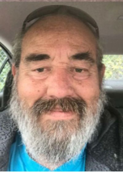 Close-up of a bearded man inside a car.