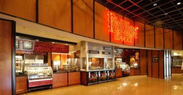 Seafood restaurant with illuminated sign and display counters.