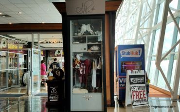 Sports memorabilia display and StubHub kiosk in a public area.