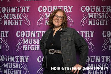 Woman posing happily at Country Music Night event.