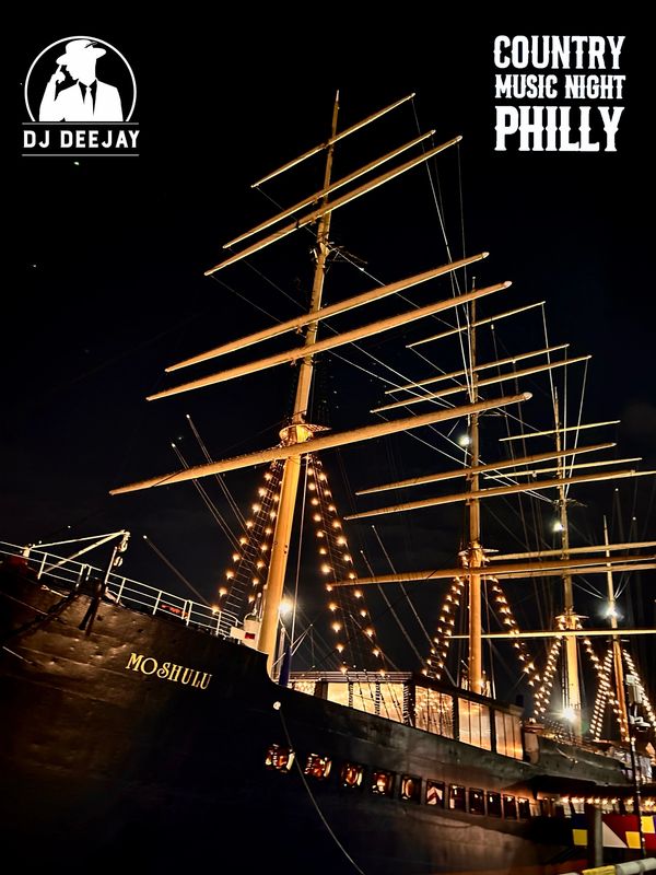 Illuminated ship at night with text for country music night in Philly.