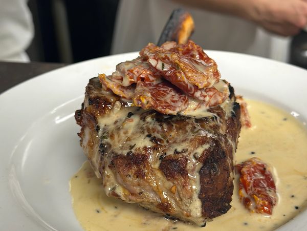 Steak with creamy sauce and sun-dried tomatoes.