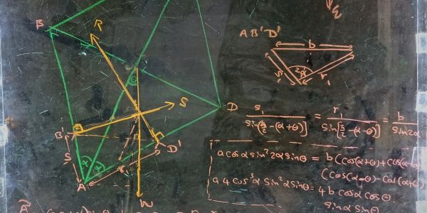 Geometry and trigonometry formulas and diagrams on a blackboard.