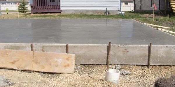 Freshly poured concrete foundation slab for a building.