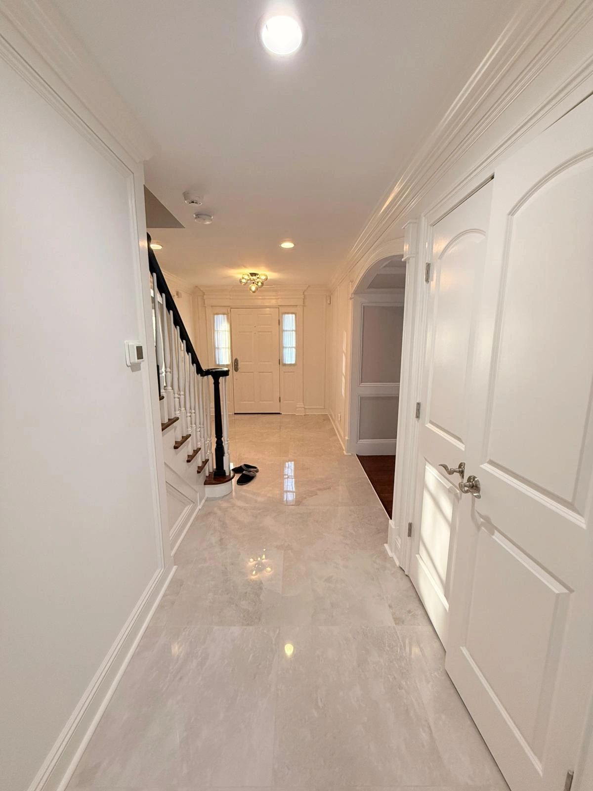 Bright hallway with white walls and staircase