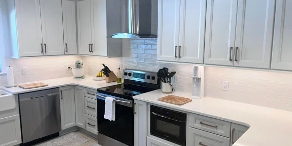 Modern kitchen with white cabinets and stainless steel appliances. In Flushing, MI.  Cabinetry in Ge