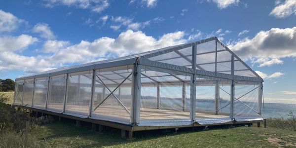 Panoramic, clear marquee next to beach

