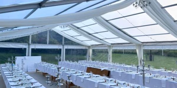 Elegant wedding marquee interior in Perth with clear roof panels, round guest tables and luxury even