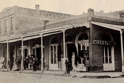 Historic street scene with people outside Meyer &amp; Frank store.