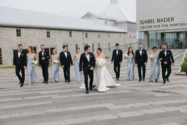 Wedding party dressed in white, black, and light blue. 