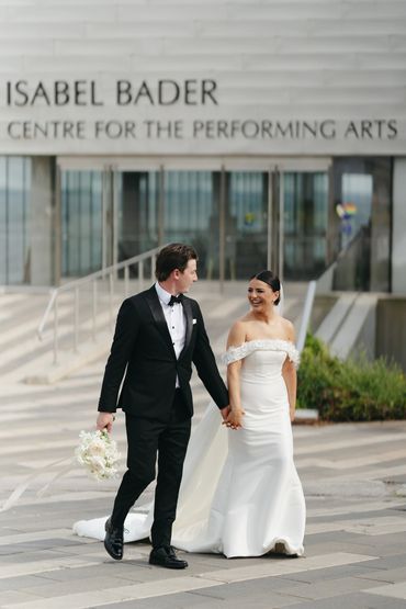 Newlyweds taking a moment outside of the Isabel Bader Center