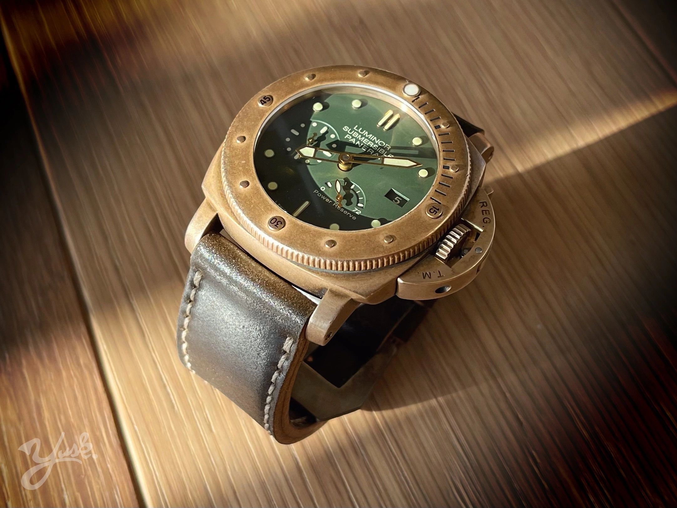Close-up of a vintage Luminor Submersible Panerai watch with a leather strap.