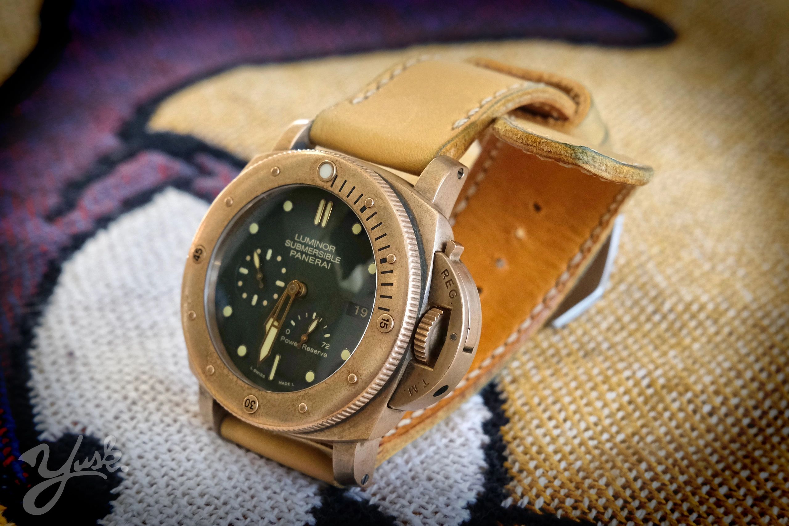 Close-up of a Luminor Submersible Panerai watch with a leather strap.