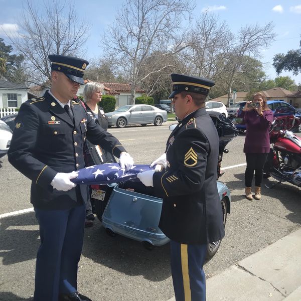 Two soldiers folding an American flag.