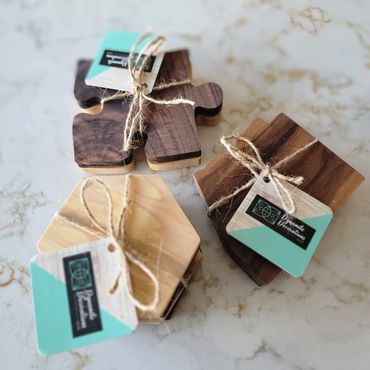 Handcrafted wooden coasters tied with twine and branded tags.