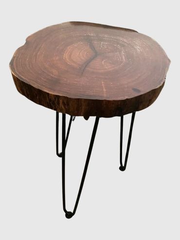 Rustic wooden slab table with metal hairpin legs.